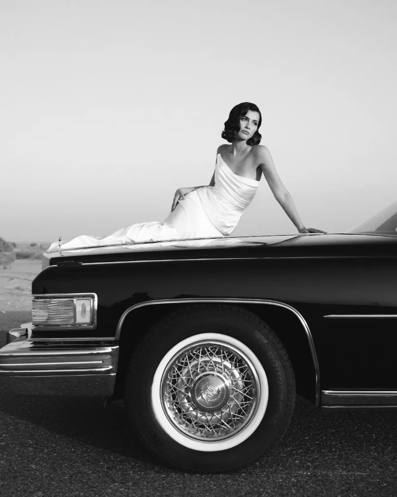 Editorial portrait in gown on a classic Cadillac, black and white
